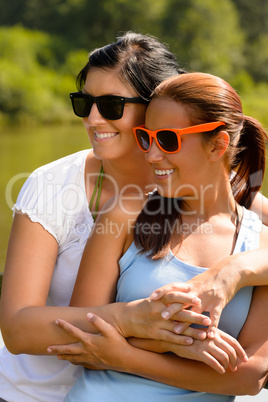 Mother and daughter relaxing in park smiling