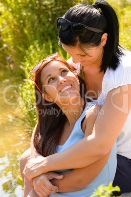 Mother holding her teen daughter in arms