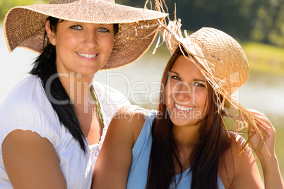 Mother and daughter relaxing outdoors summer teen