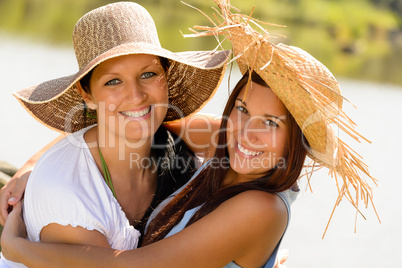 Mother and daughter hugging outdoors summer teen