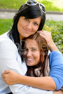 Mother holding teen daughter in her arms