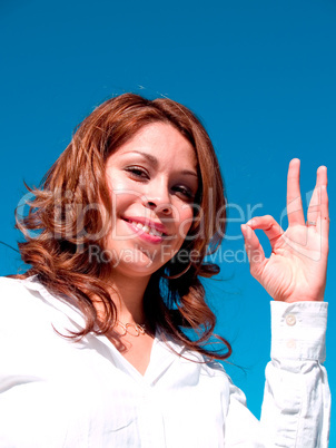 Woman making an OK gesture.