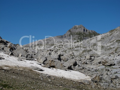 Rocks And Snowfield In The Alps