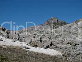 Rocks And Snowfield In The Alps