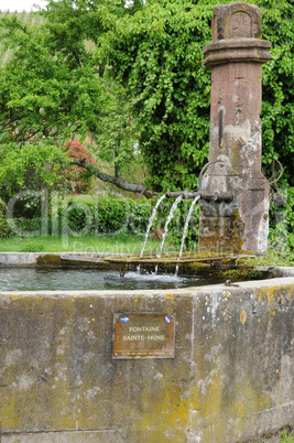 Alsace, a picturesque old fountain in Hunawihr