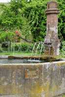 Alsace, a picturesque old fountain in Hunawihr