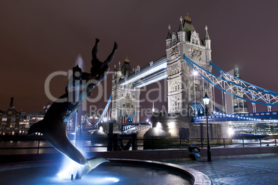 fountain and tower bridge illuminated