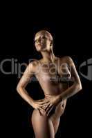 Beauty naked woman posing in metal skin statue