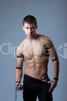 athletic man dance striptease with chain