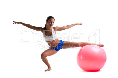 Young woman doing split with fitness ball isolated