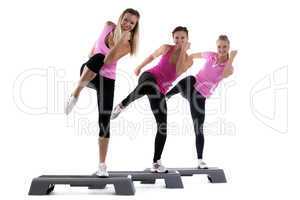 young group women training on stepper isolated