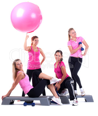 group of fitness instructors stand with accesories
