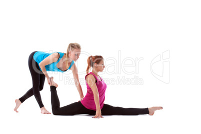 fitness instructor help young woman doing stretch