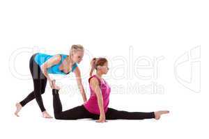 fitness instructor help young woman doing stretch