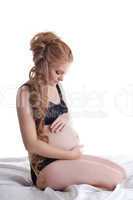young pregnant woman sit in black lingerie
