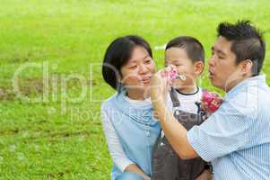 Asian family playing bubble wand