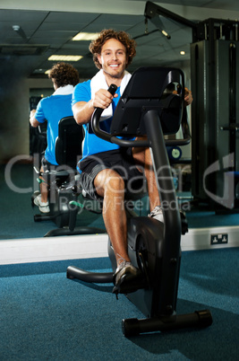 Smart guy working out in the exercise bike