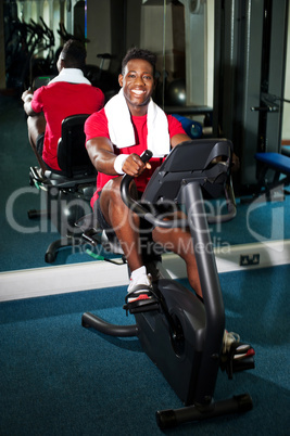 Young guy burning calories, pedaling fast