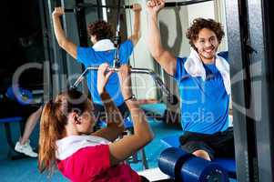 Friends working out together in a multi gym