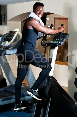 Young smiling fit african male burning calories