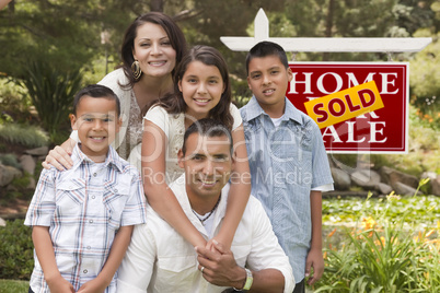 Hispanic Family in Front of Sold Real Estate Sign