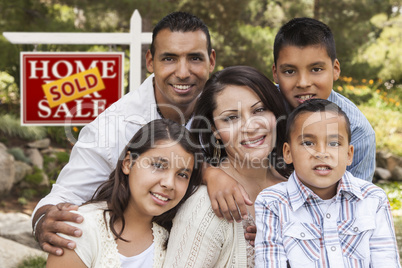 Hispanic Family in Front of Sold Real Estate Sign