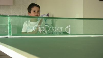 Little boy learning ping pong