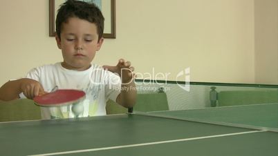 Little boy learning ping pong