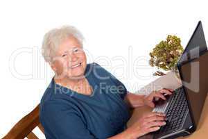 Happy senior lady using a laptop