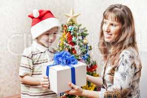 Mother and son with new year present or christmas holiday gift b