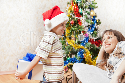 Mother and son with new year present or christmas holiday gift b