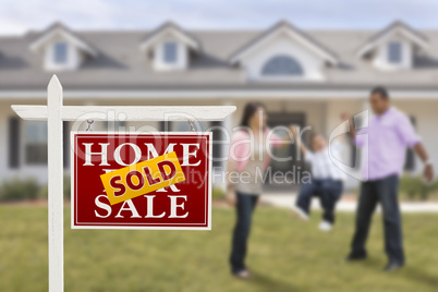 Sold Real Estate Sign and Hispanic Family in Front of House
