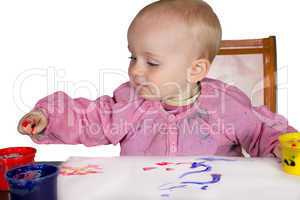 Cute baby experimanting with paint