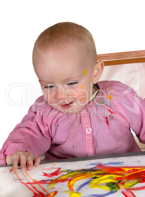 Happy baby girl finger painting