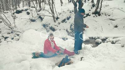 Teenage Couple Enjoying Winter Holidays in Forest