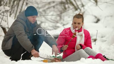 Winter Picnic By Bonfire in Snow Forest