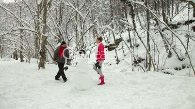 Funny Teenage Couple Enjoying in Snow and Winter