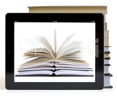 Books and tablet computer isolated on white