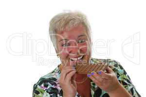 Seniorin beisst in Tafel Schokolade