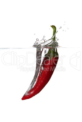 falling red pepper in water