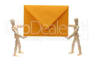 two wooden dolls holding yellow envelope