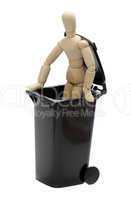 wooden doll in garbage bin