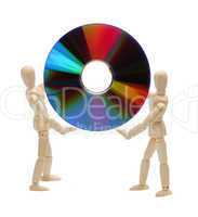 wooden dolls holding a cd