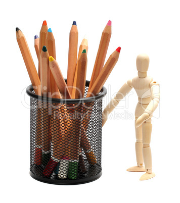 wooden doll with pencils in garbion cage