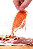 Thinly Sliced ??Spanish Jamon with a Hand
