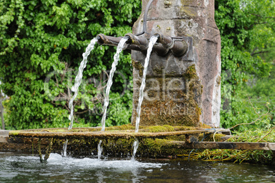 Alsace, a picturesque old fountain in Hunawihr