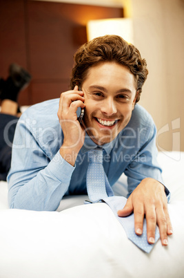 Relaxed young businessman communicating with his partner