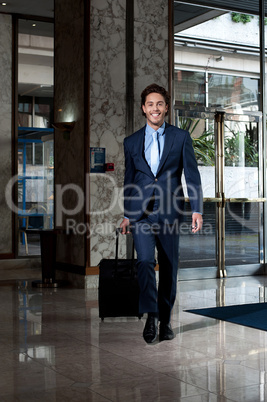 Business executive entering hotel lobby