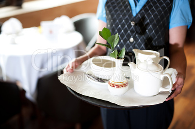 Cropped image of a woman holding tea tray