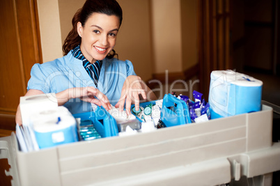 Working staff arranging toiletries in a wheel cart